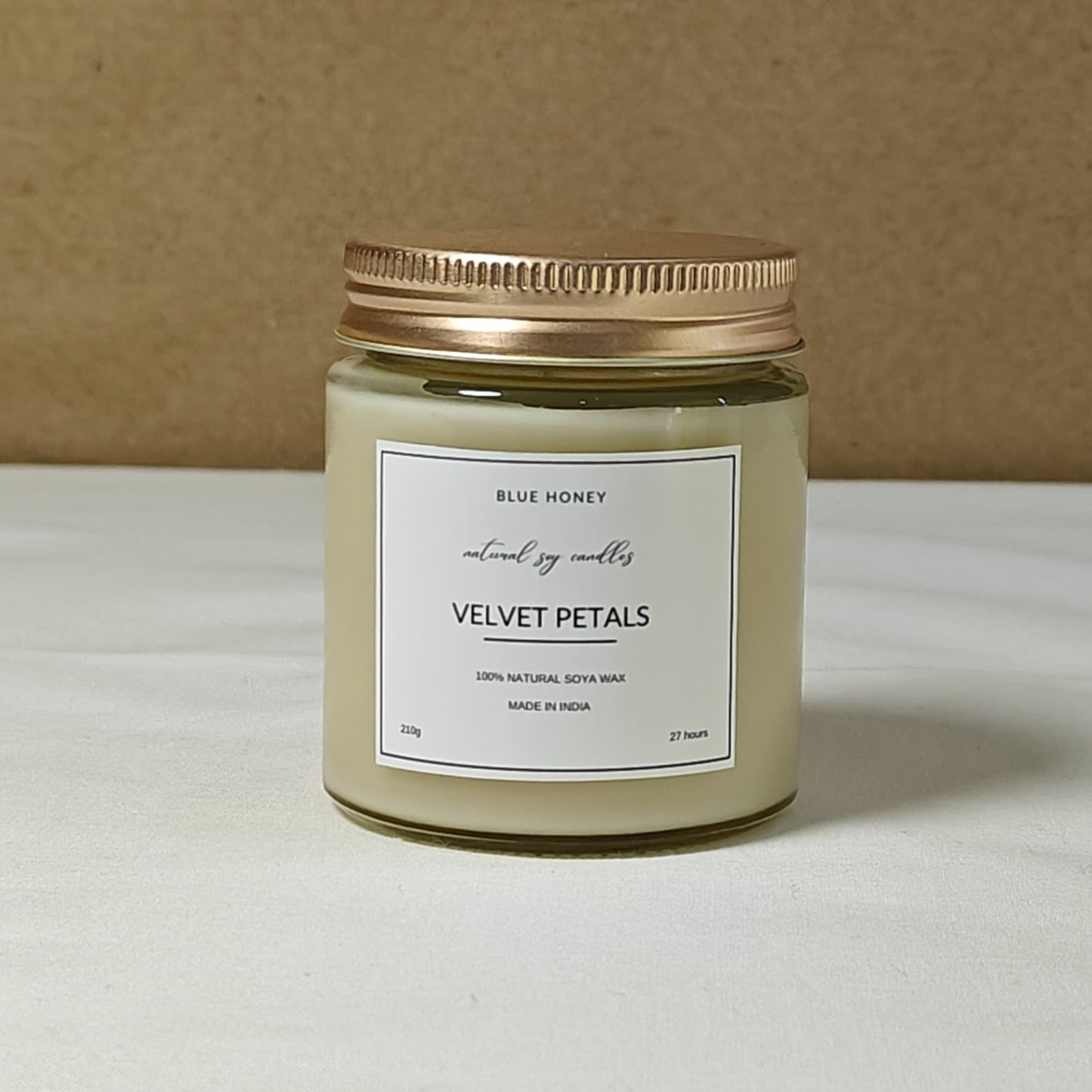 blue honey rose scented soy wax candle in a mason jar with gold lid