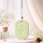 Lemongrass car aroma tag hanging diffuser with a subtle flame design, presented in a lifestyle setting.