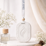 White oval car aroma tag diffuser with 'Blue Honey' branding, hanging from a ribbon.
