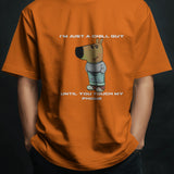 Men's orange cotton graphic tee with 'I'm Just a Chill Guy... Until You Touch My Phone' quote and cartoon print.