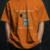 Orange "I Don't Need Therapy" Chill Guy graphic t-shirt for men, featuring a cartoon dog and humorous text.