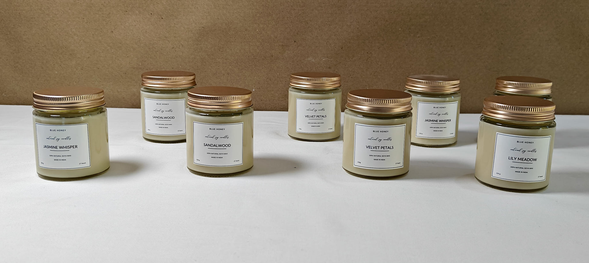 8 mason jar soy wax candles lined up on a table