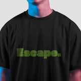 Black oversized t-shirt featuring "Escape" in a green maze-like pixelated font on the front.