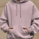 Front view of the Dreamin' Oversized Unisex Hoodie in a soft pink color, featuring a kangaroo pocket.