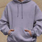 Dreamin' oversized unisex hoodie in lavender, worn by a person with hands in the front pocket.