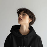 Front view of a black Perfectly Imperfect heavyweight oversized hooded sweatshirt with minimalist typography.
