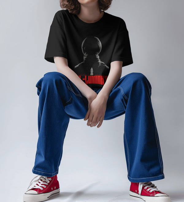 Oversized black graphic t-shirt featuring Diljit Dosanjh's 'Diluminati' design, worn by a person sitting.