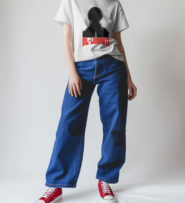 Oversized white Diljit Dosanjh 'Diluminati' graphic t-shirt worn by a person in blue jeans and red sneakers.