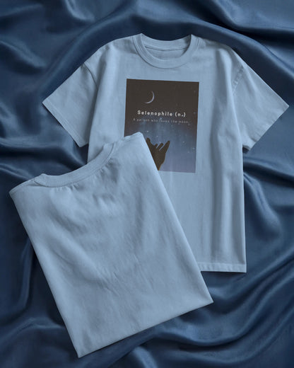 oversized baby blue Selenophile tshirt laying on a blue sheet in the background