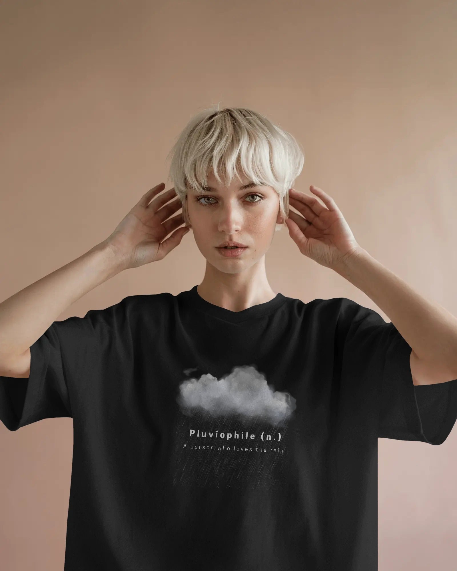 a white female model with short blonde hair wearing an oversized black Pluviophile tshirt