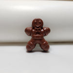 Miniature hand-painted brown cement gingerbread man fridge magnet, perfect for festive Christmas decor.