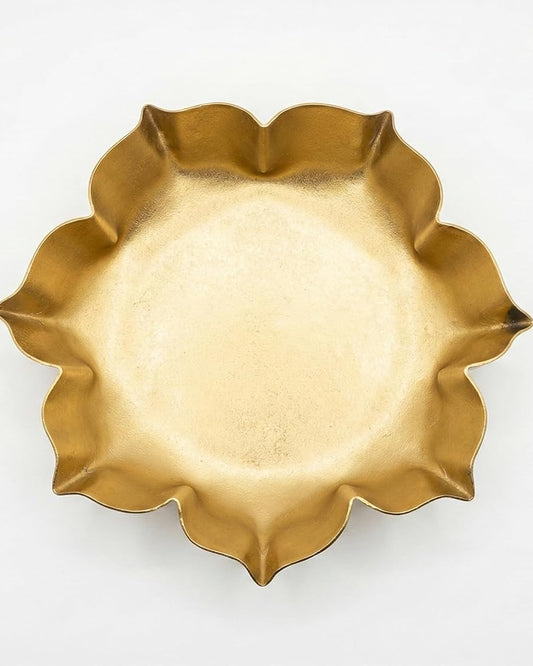 Gold-tone lotus-shaped urli bowl with ruffled edge, perfect for accent decor.