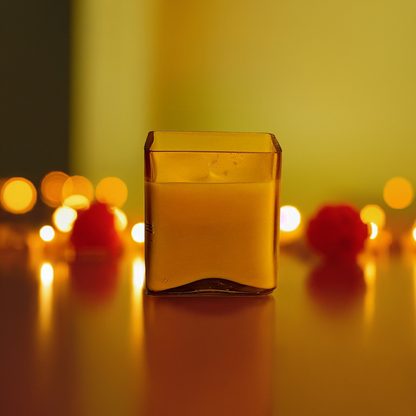 Yellow glass jar candle with warm lighting