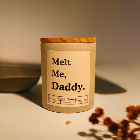 Matte white glass jar candle with 'Melt Me, Daddy' label.