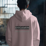 Back view of a black and white Dreamin oversized unisex hoodie with streetwear typography.