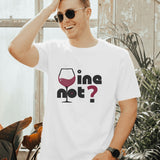 White "Wine Not?" graphic t-shirt worn by a smiling man in a lifestyle setting.