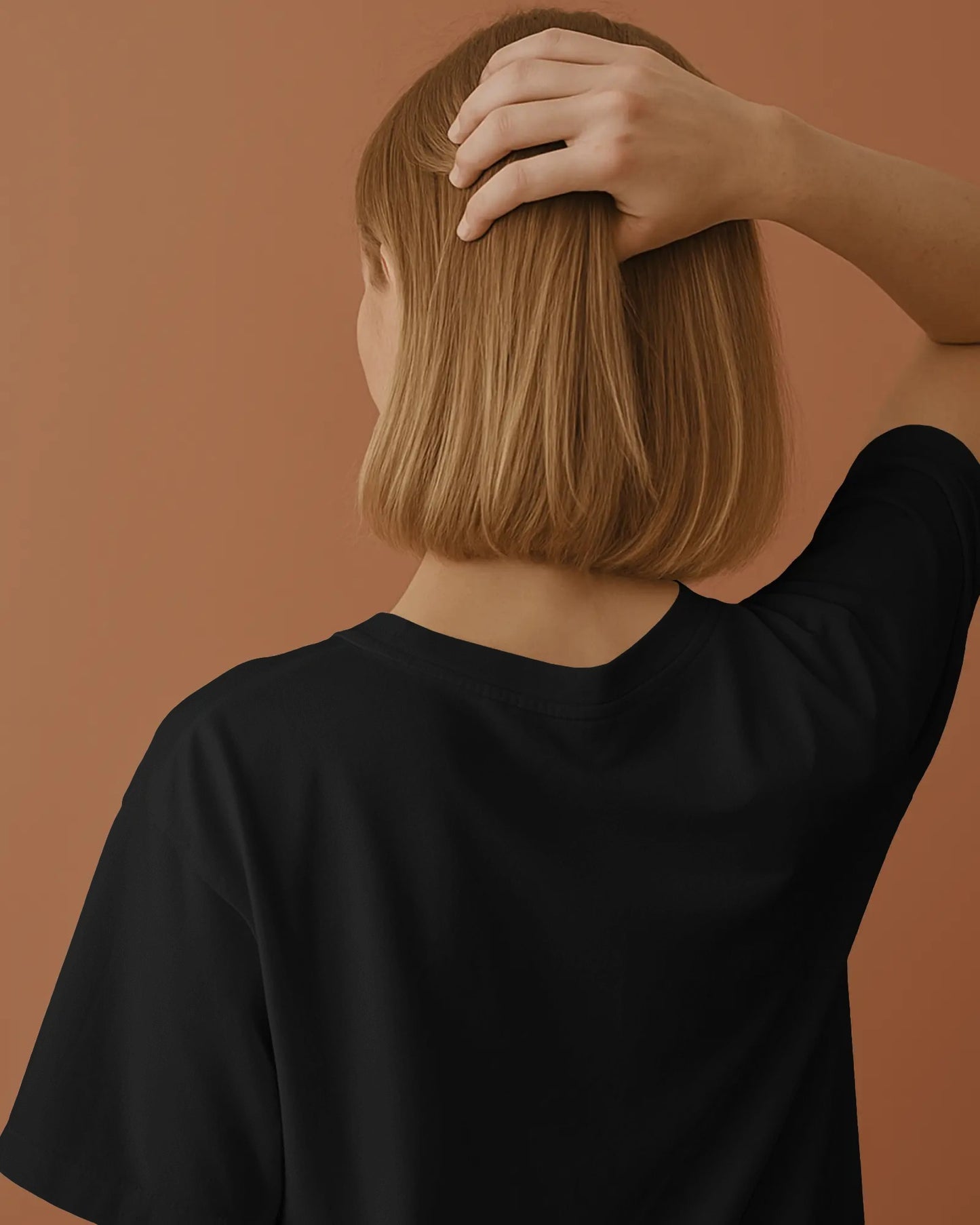 a female model showing the plain back of oversized black Pluviophile tshirt