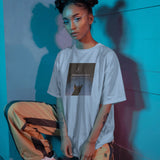 Minimalist Unisex Oversized T-shirt in white cotton featuring a 'Selenophile' graphic print on the front.