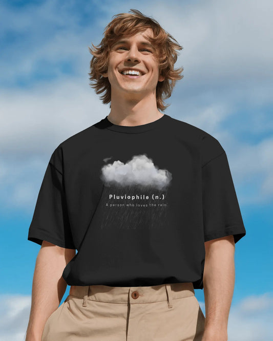 a white male model standing with a smile on his face wearing an oversized black Pluviophile tshit 