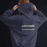 Back view of a unisex oversized black hoodie with 'Dreamin' graphic print, perfect for casual streetwear.