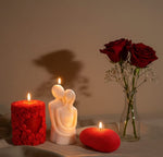Valentine sculpted candles: a couple, a floral heart, and an oval candle with roses and red roses in a vase.