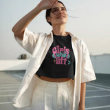 Lifestyle image of a woman wearing a black 'Girls Who Lift' crop top and white pants, shielding her eyes from the sun.