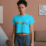 Front view of a woman wearing the Rainbow Bloom Crop Top, featuring colorful flowers and a vibrant design.