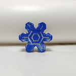 Hand-painted blue miniature cement art Christmas snowflake fridge magnet, front view.