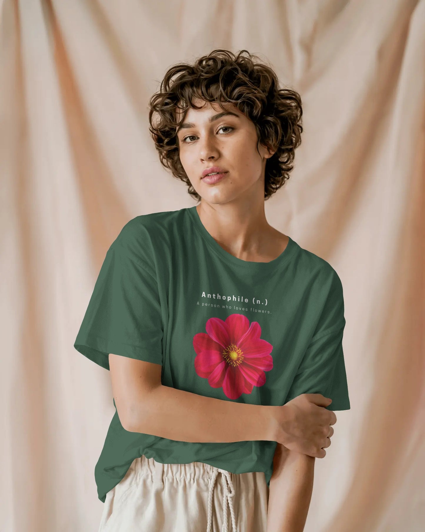 a female model standing wearing an oversized Bottle Green Anthophile tshirt 