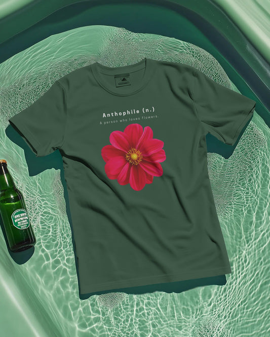 an oversized Bottle Green Anthophile tshirt laying on a slighter light green background with a green bottle on the side 