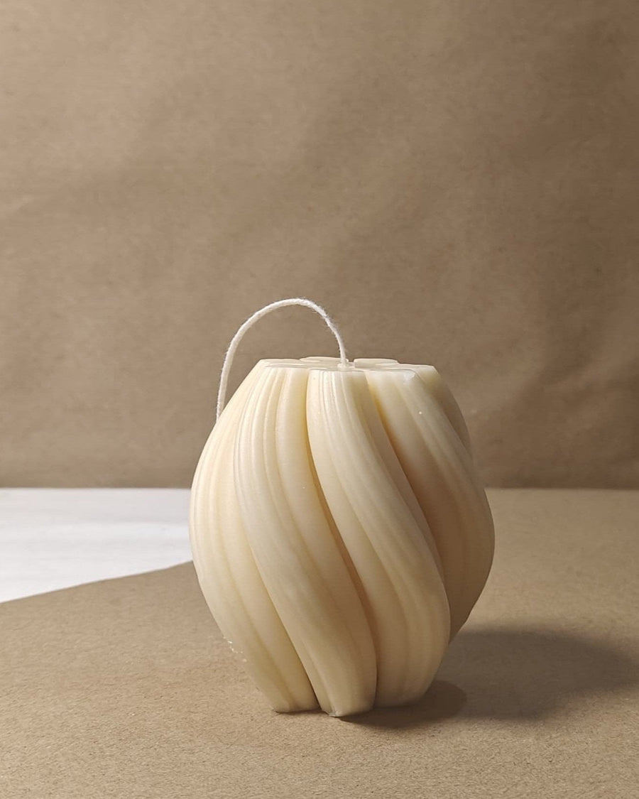 Eco-friendly 4-inch soy wax swirl pillar candle in a natural cream color, offering an elegant and clean burn.