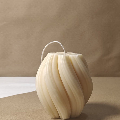 Eco-friendly 4-inch soy wax swirl pillar candle in a natural cream color, offering an elegant and clean burn.