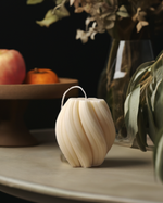 Eco-friendly 4" soy wax swirl pillar candle in a creamy white color, offering an elegant and clean burn.