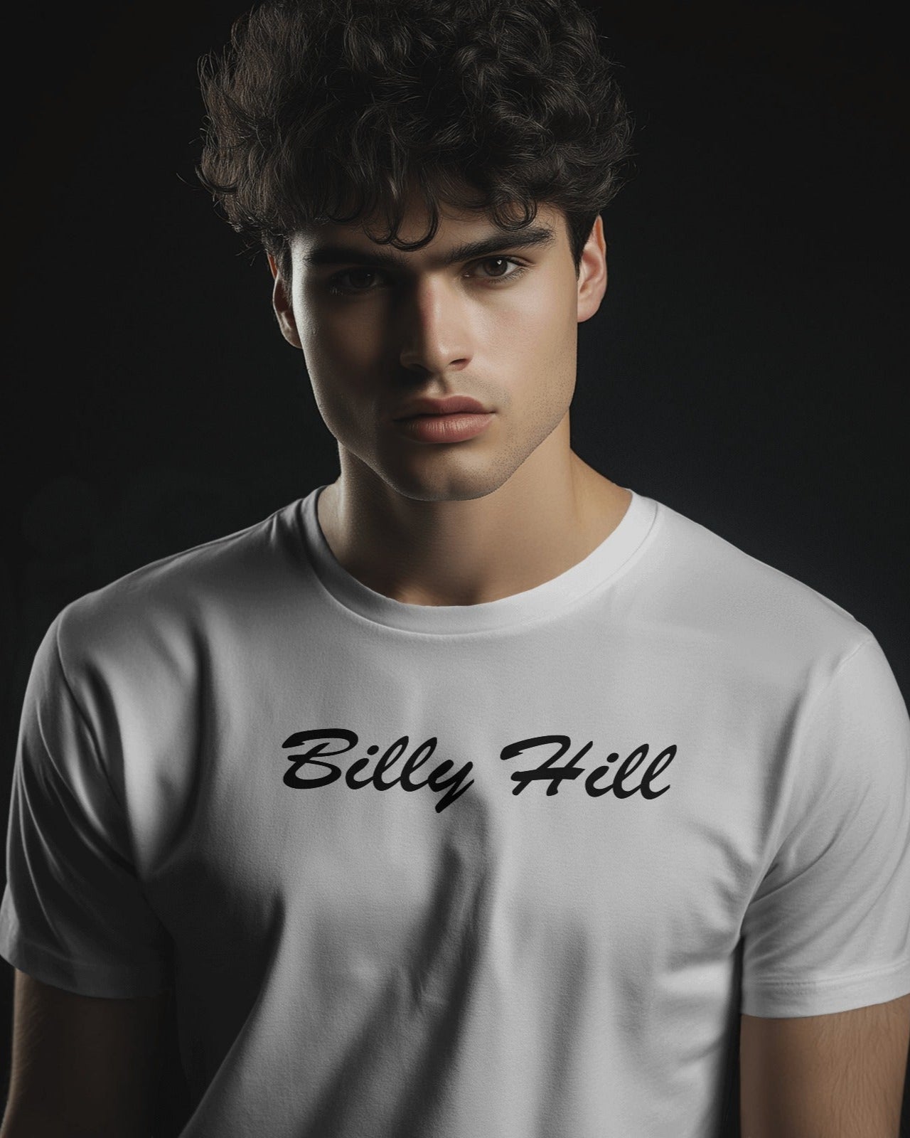 A white male model wearing a white tshirt with the caption Billy Hill
