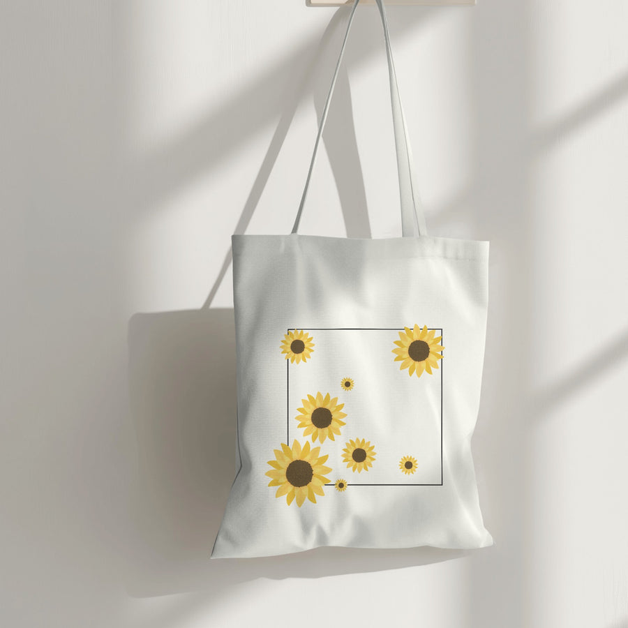 White canvas tote bag with a minimalist sunflower print, perfect for eco-friendly shopping and everyday style.