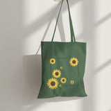 Green eco-friendly tote bag with a minimalist sunflower print, perfect for stylish grocery shopping.
